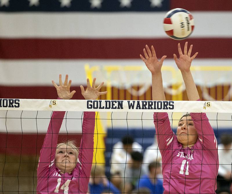 Sterling’s Emma Sinn (left) and Natalie Eddinger go up for a block against Mendota Thursday, Oct. 24, 2024, in Sterling.
