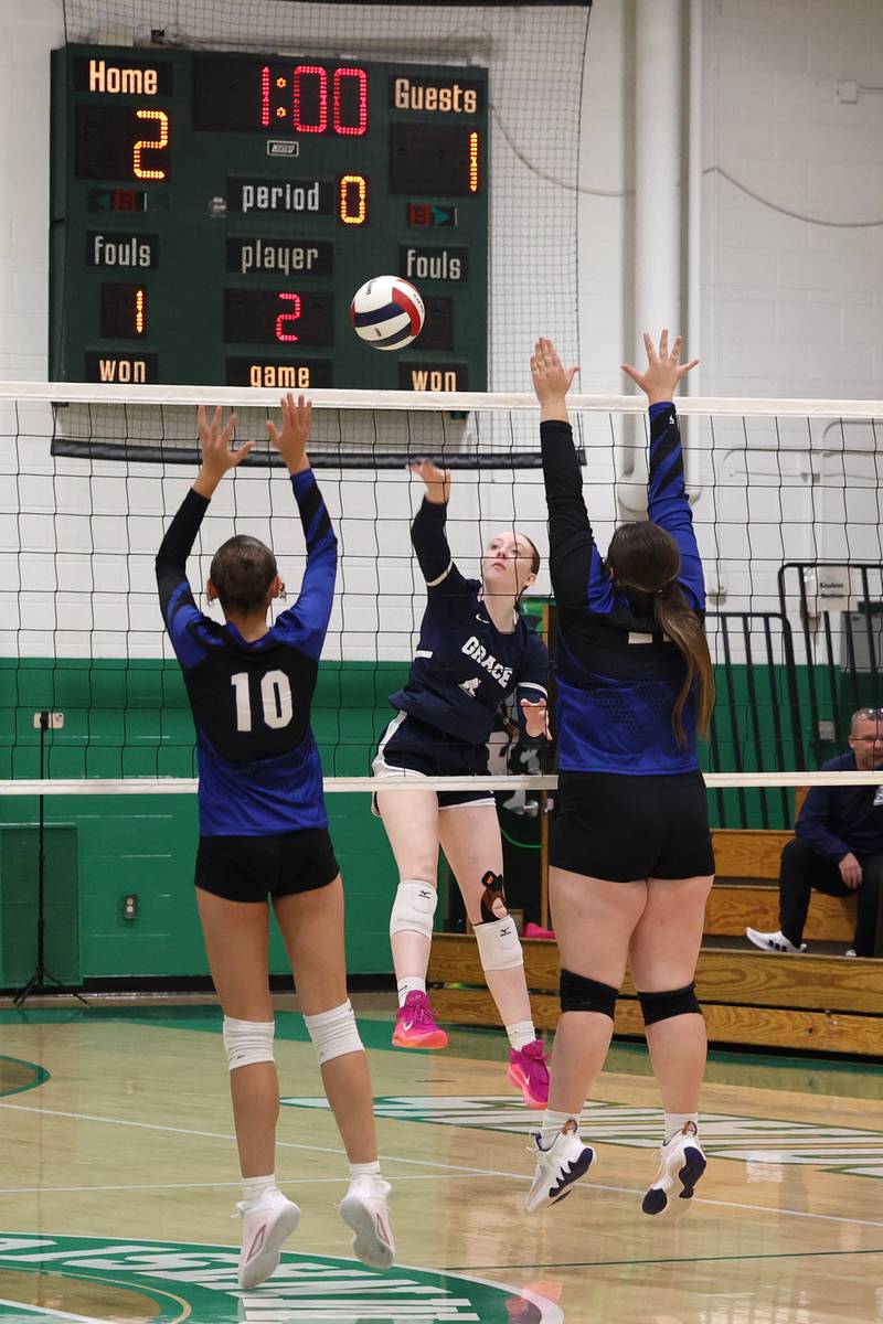 Grace Christian's Sarah Rauwolf hits the ball over Clifton Central's Ellie Perzee, left, and Gemma Sifrit during Grace Christian's victory in two sets, 25-20, 25-16, in the IHSA Class 1A Dwight Regional quarterfinals on Monday, Oct. 27, 2025.