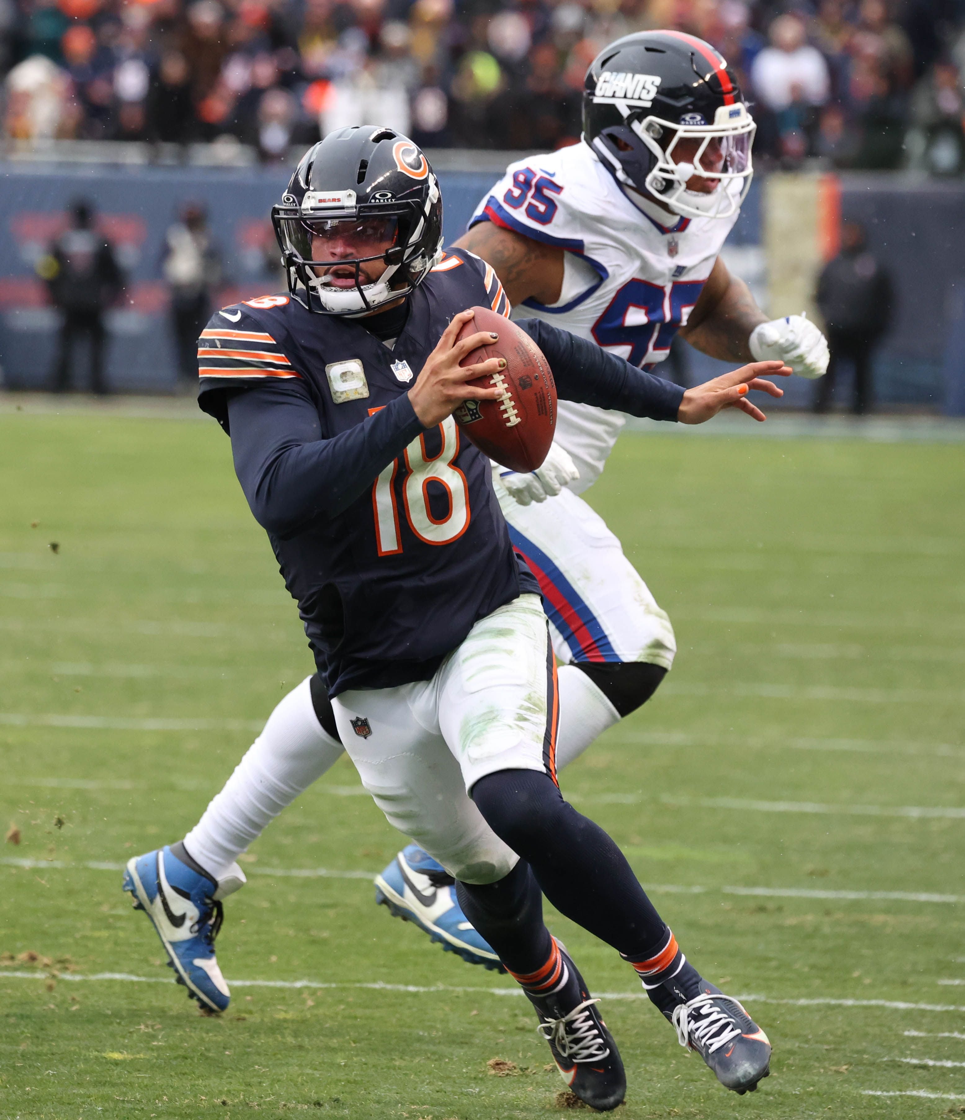 Chicago Bears quarterback Caleb Williams goes by New York Giants defensive tackle Roy Robertson-Harris on his way to a go-ahead touchdown Sunday, Nov. 9, 2025, during their game at Soldier Field in Chicago.