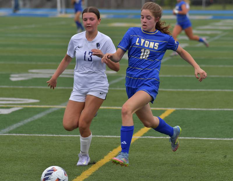 Downers Grove North’s Grace Watland and Lyons Township’s Mia Anderson try to catch up with the ball during their Class 3A Lyons Regional final on May 23, 2026 at Lyons Township High School in LaGrange.