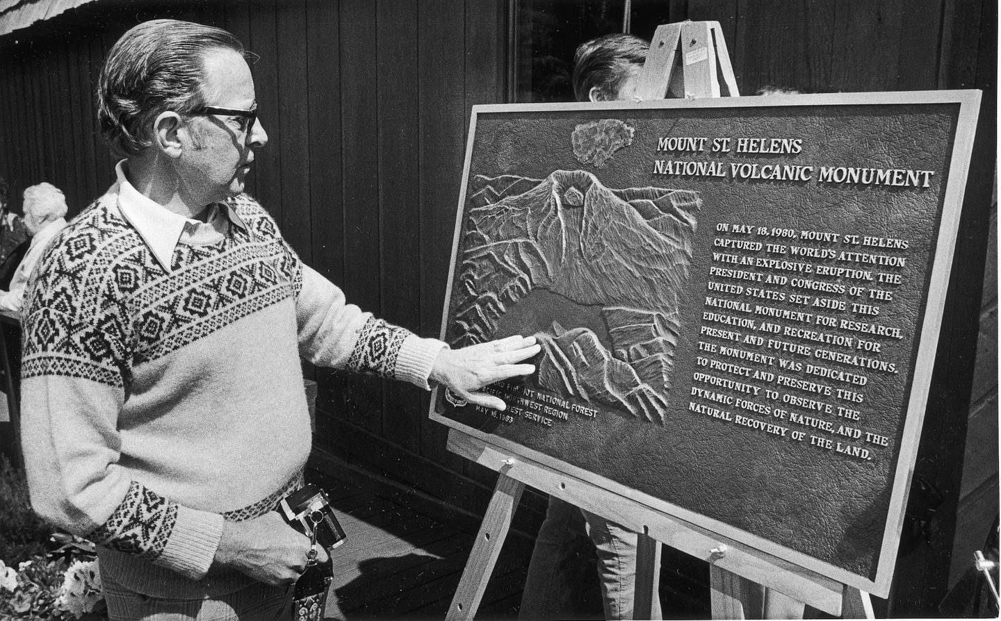Tom Johnston of Chicago examines a bronze plaque unveiled a the dedication of the Mount St. Helens Volcanic Monument in Toledo, Washington, May 18, 1983. The father of David Johnston, a U.S. Geological Survey scientist killed  after alerting the world to the eruption of Mount St. Helens in May of 1980, said his son would have been proud of the monument.