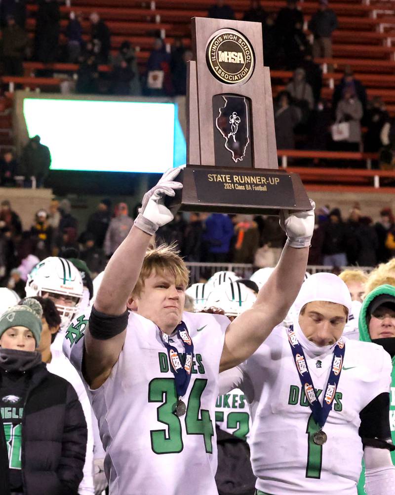 York’s Jimmy Conners holds the state second place trophy after their Class 8A state championship game loss to Loyola Saturday, Nov. 30, 2024, in Hancock Stadium at Illinois State University in Normal.