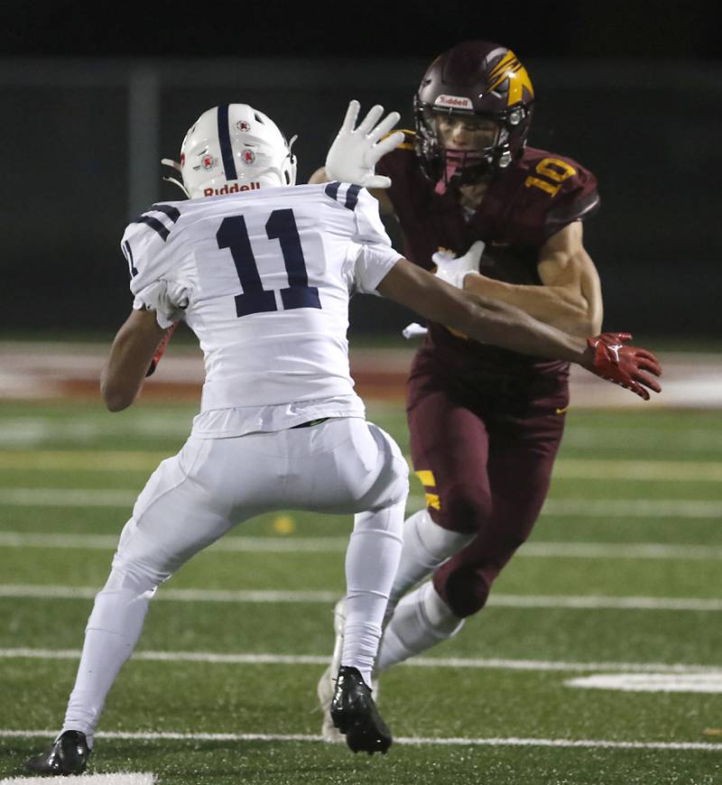 Richmond-Burton's Max Loveall tries to get away from St. Viator's Montay Washington during a IHSA Class 4A first round playoff football game Friday, Oct. 27, 2023, at Richmond-Burton High School in Richmond.