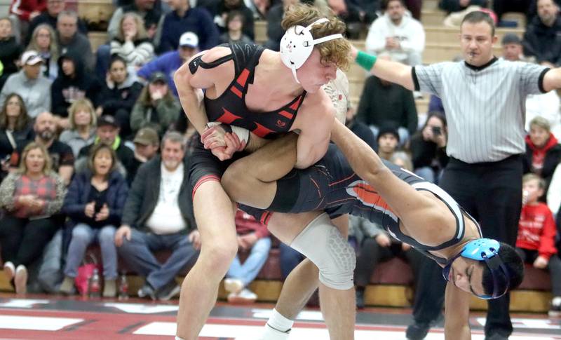 Huntley’s Alesia Pezzella (left) battles McHenry’s Ruben Melgarejo at 152 pounds in in their Fox Valley Conference dual on Friday in Huntley.