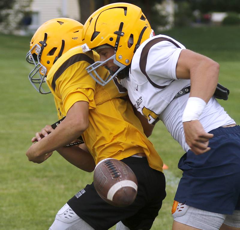 Jacobs’ Luke Gormsen causes a fumble on Tuesday, July 2, 204, during a summer football Patrice at Jacobs High School.