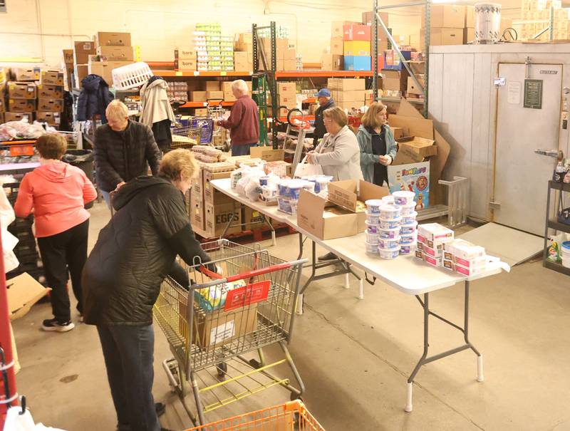 Volunteers fill carts of food during the annual Easter distribution on Wednesday, April 1, 2026 at the Hall Township Food Pantry in Spring Valley.