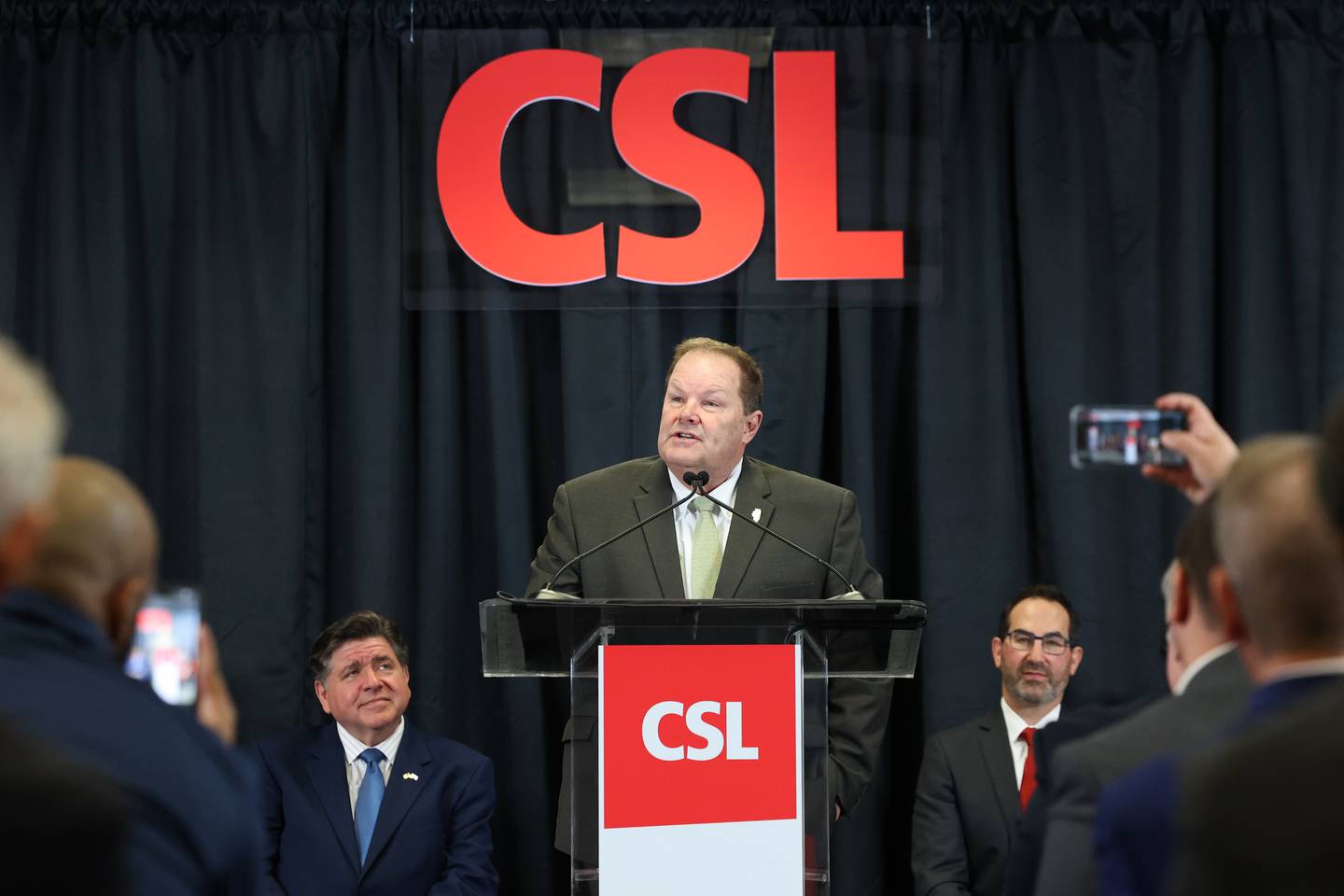 Illinois State Sen. Patrick Joyce, D-Essex, speaks at a press conference on Monday, March 9, 2026, at CSL Behring, which announced a $1.5 billion expansion to its Bourbonnais Township plant. Gov. JB Pritzker, left, was on hand at CSL Behring on Monday morning, along with many other state officials.