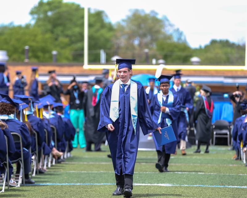 Graduands return to their seats after receiving their diplomas during the Downers Grove North graduation ceremony at the school on Sunday, May 22, 2022