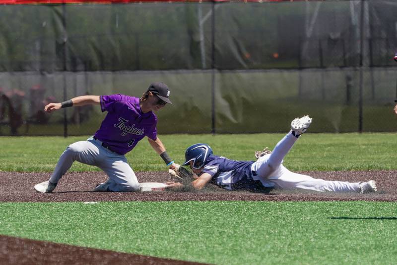 Oswego East's Dominic Battista (14) steals second base against Downers Grove North's Jude Warwick (4) during a 4A Bolingbrook Regional Championship baseball game at Bolingbrook High School on Saturday, May 25, 2024.