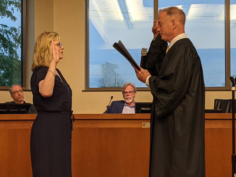 Kendall County Judge John McAdams, right, administers the oath of office to longtime Oswego resident Karen Novy, left,  who was picked during a special Oswego Village Board meeting July 5 to fill a vacancy on the board.