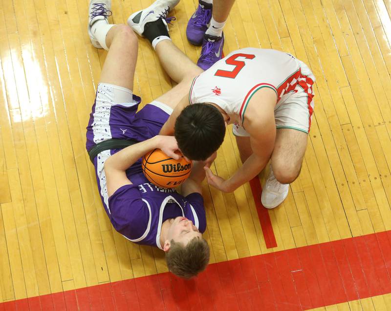 Rochelle's Brody Bruns and L-P's Erick Sotelo battle for a rebound on the floor on Friday, Feb. 13, 2026 in Sellett Gymnasium at L-P High School.