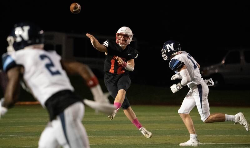 Benet Academy's Jacob Hoeppel (12) throws a pass against Nazareth Academy during a football game at Benedictine University in Lisle on Friday, Oct 21, 2022.