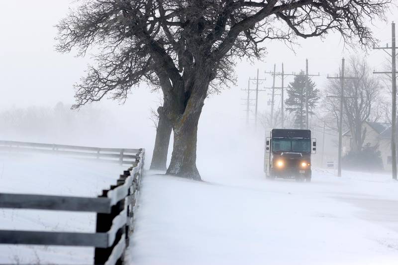 A delivery truck emerges from drifting snow along Route 23 just North of Interstate 90 Friday morning.
