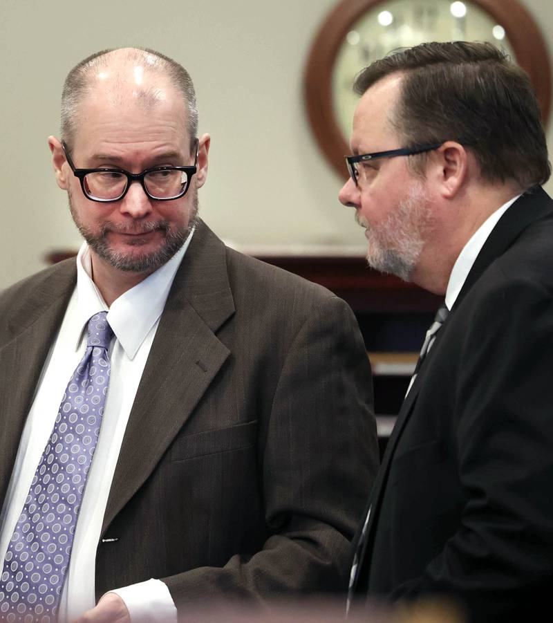Jonathan Hurst (left) talks to one of his lawyers Chip Criswell Thursday, Jan. 23, 2025, during his trial at the DeKalb County Courthouse in Sycamore. Hurst is charged in the 2016 slayings of Sycamore elderly mother and son Patricia and Robert Wilson.