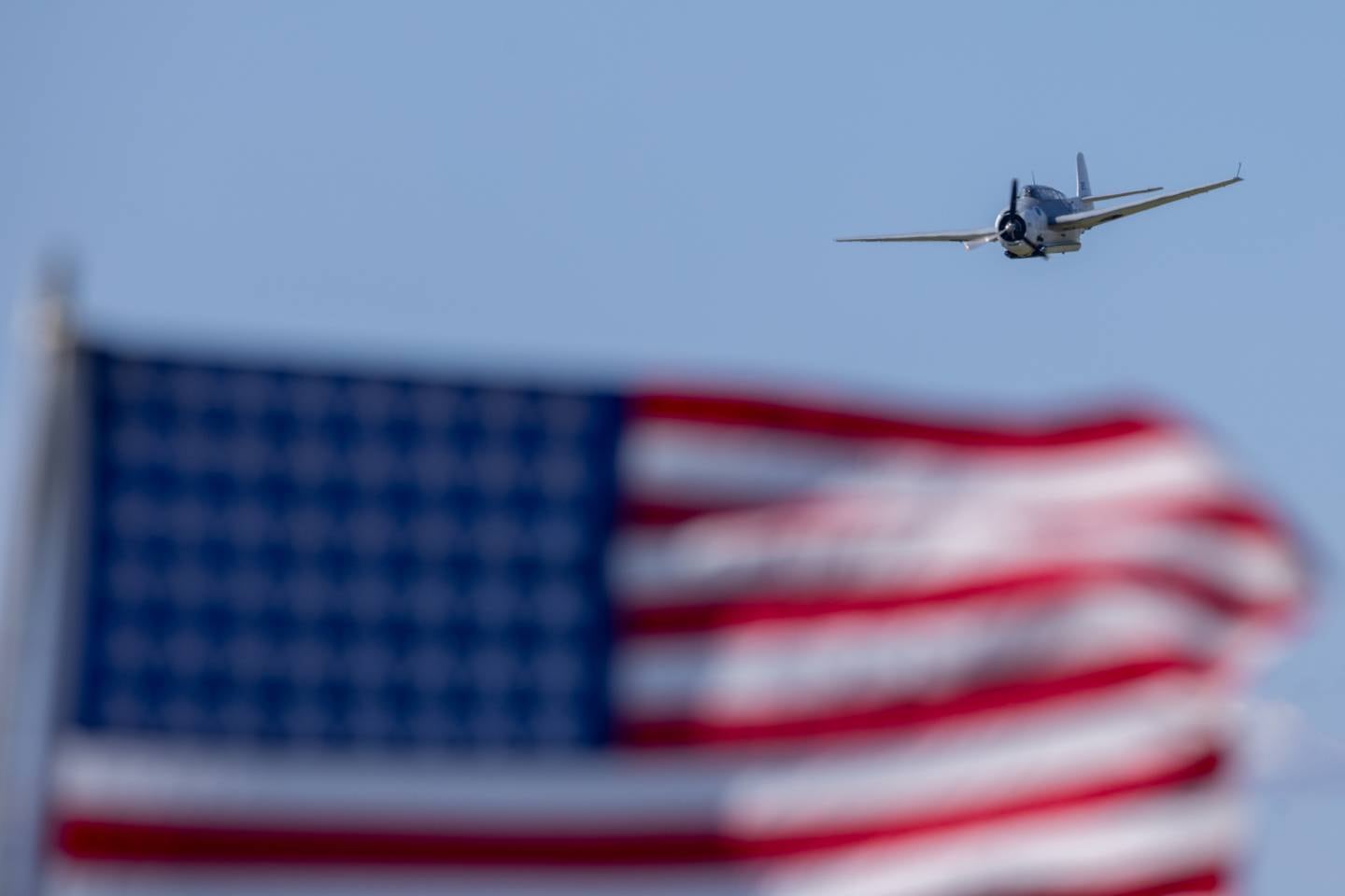 A TBM Avenger flies over the American Flag during the 10th annual TBM Avenger Reunion and Airshow on Saturday, May 17, 2025 at the Illinois Valley Regional Airport in Peru.