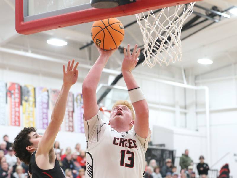 Indian Creek's Isaac Willis scores on a drive to the basket against Woodland's Brezdyn Simons during the Class 1A Sectional Semifinal game on Wednesday, March 4, 2026 at Amboy High School.