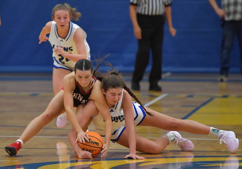 Benet's Sailer Jones and Lyons Township's Emma O' Brien (right) go to the floor after a loose ball during a game on November 19, 2024 at Lyons Township High School in LaGrange.