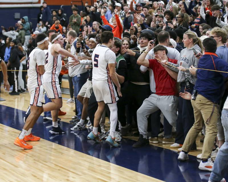 Oswego celebrates with the student section after their win over Oswego East Friday, Jan 09, 2025 in Oswego.