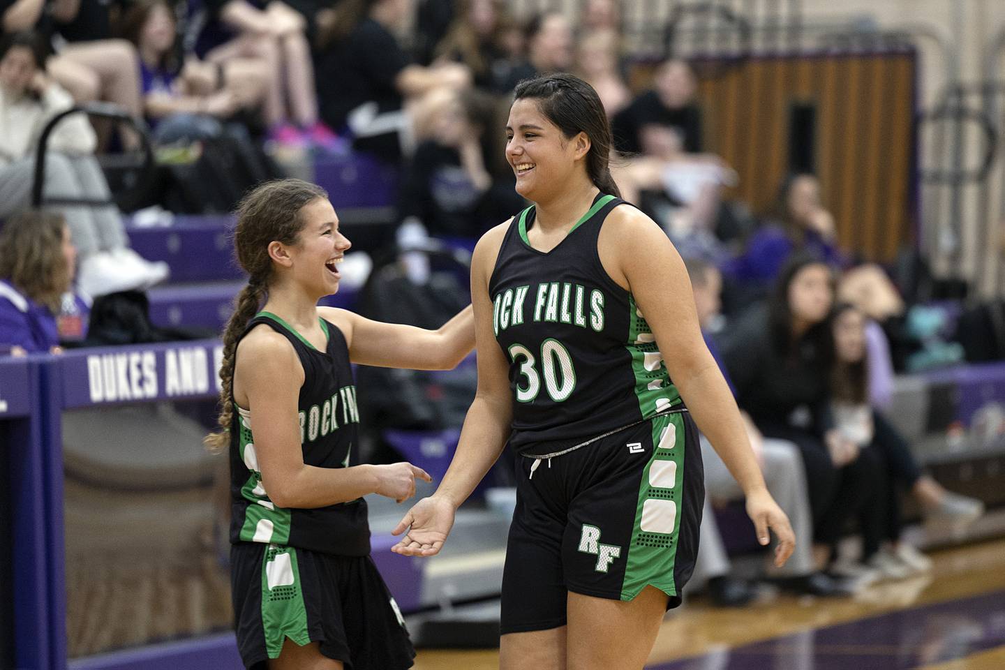 Rock Falls’ Taylor Reyna (right) celebrates hitting a three point shot at the end of the half against Dixon Wednesday, Feb. 1, 2023.