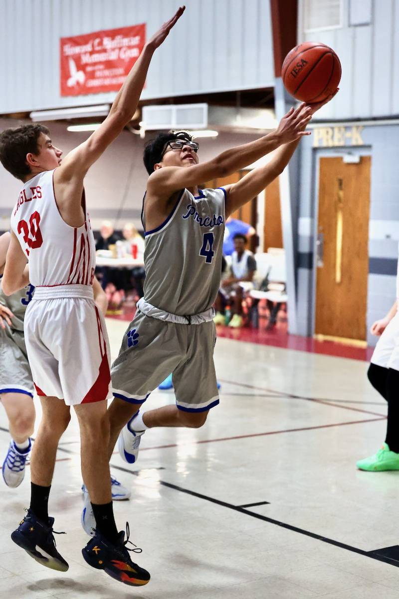 Princeton's Michel Sanchez shoots an layup against PCA's Matthew Gibson in Thursday's JV game at Howard Hoffman Memorial Gymnasium.