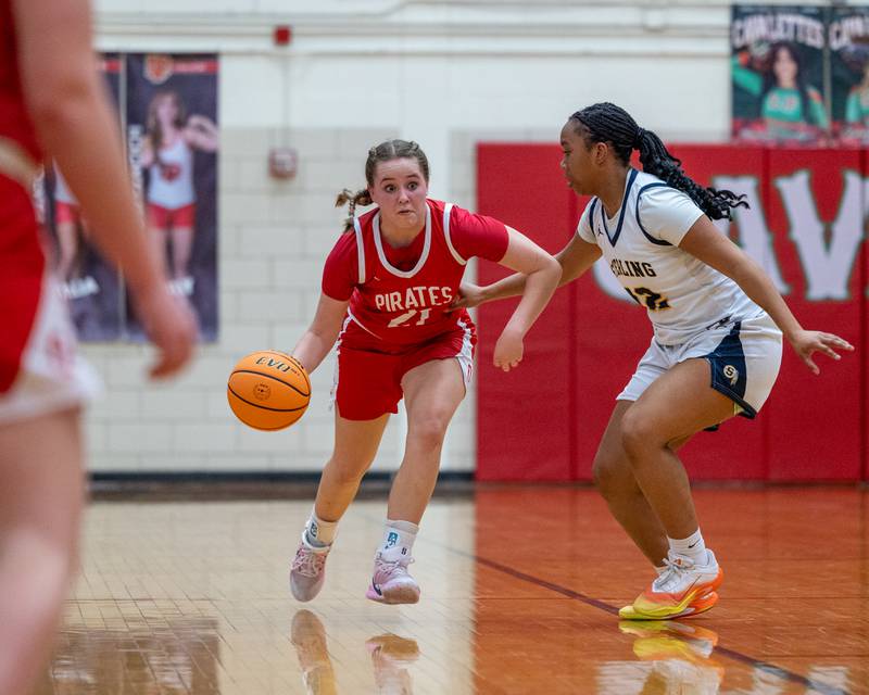 Ottawa's Hailey Thrush (21) dribbles ball as Joslyn Green (22) of Sterling defends at hip during Regional Championship game on Thursday, Feb. 19, 2026 in Sellett Gymnasium at L-P High School.