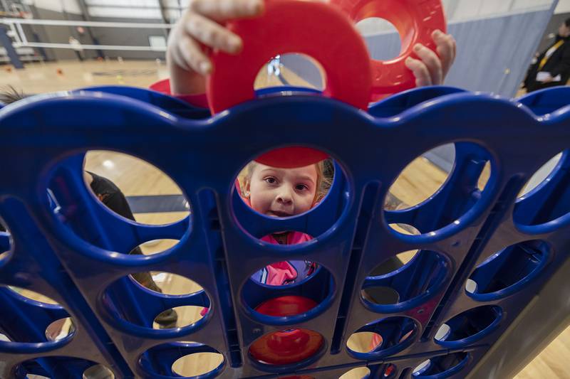 A young student stacks rings for a game of Connect Four on Tuesday, Jan. 31, 2023 in Dixon.