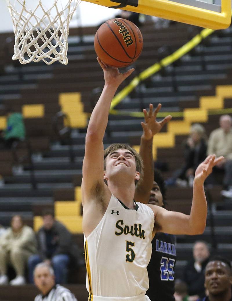 Crystal Lake South's Brady Schroeder shoots the ball in front of  Larkin’s Armani Ivy during a Hinkle Holiday Classic basketball game Wednesday, Dec. 28, 2022, at Jacobs High School in Algonquin.