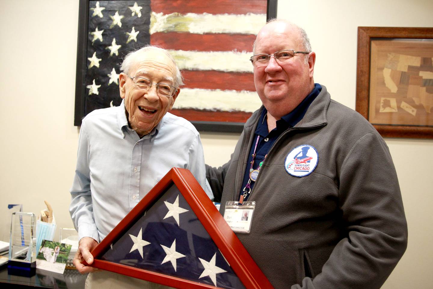 Dan Harrington, executive director of Oak Trace senior living in Downers Grove, talks with resident Jim Leichti, a World War II veteran. Harrington works significantly with Honor Flight, which offers a full day of traveling to Washington D.C. with veterans to visit war memorials. Harrington has participated in more than 30 flights.