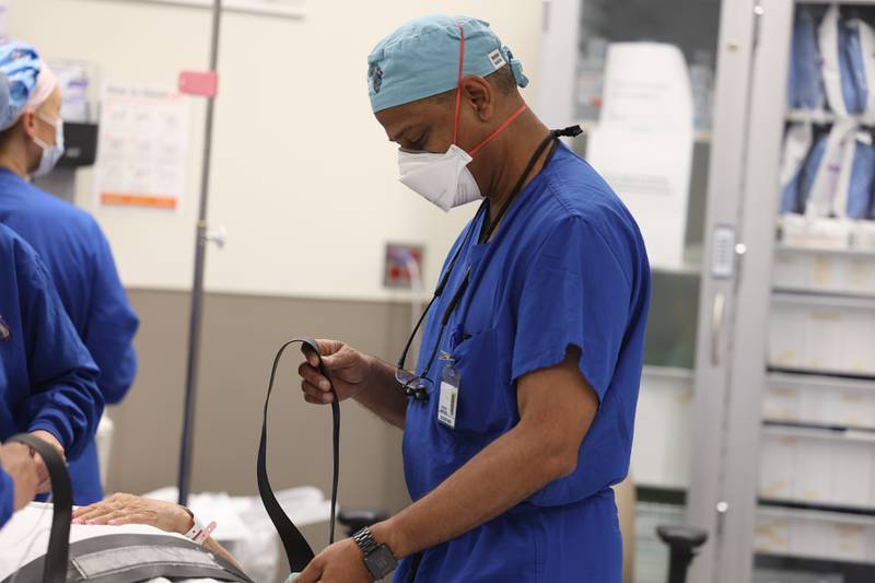 Dr. Rajeev Mehta helps prep a patient before implanting an Inspire device to help with sleep apnea at Silver Cross Hospital. Wednesday, June 28, 2022 in New Lenox.