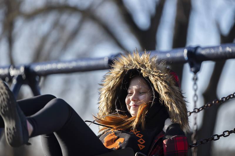 Bella Daly, 14, of Amboy is all smiles as she soars on a swing Monday, Feb. 12, 2024 at EC Smith Park in Dixon. Near fifty degree weather brought people outside for fun and activities.