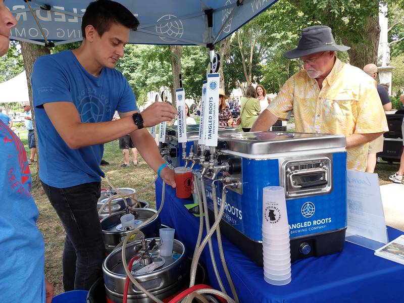 Mike Billy of Tangled Roots Brewing Company of Ottawa pours a beer during the inaugural Drinkin' with Lincoln brew fest Saturday, July 27, 2024, at Washington Square in Ottawa.