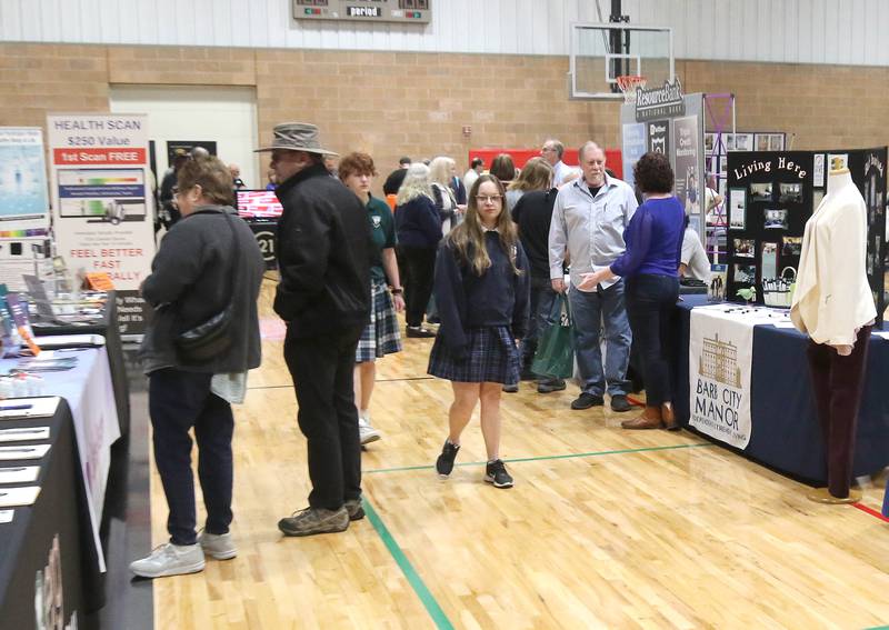 Attendees visit the tables during the DeKalb Chamber of Commerce’s Local Showcase and Job Fair Thursday, April 25, 2024, at the DeKalb Sports and Recreation Center.