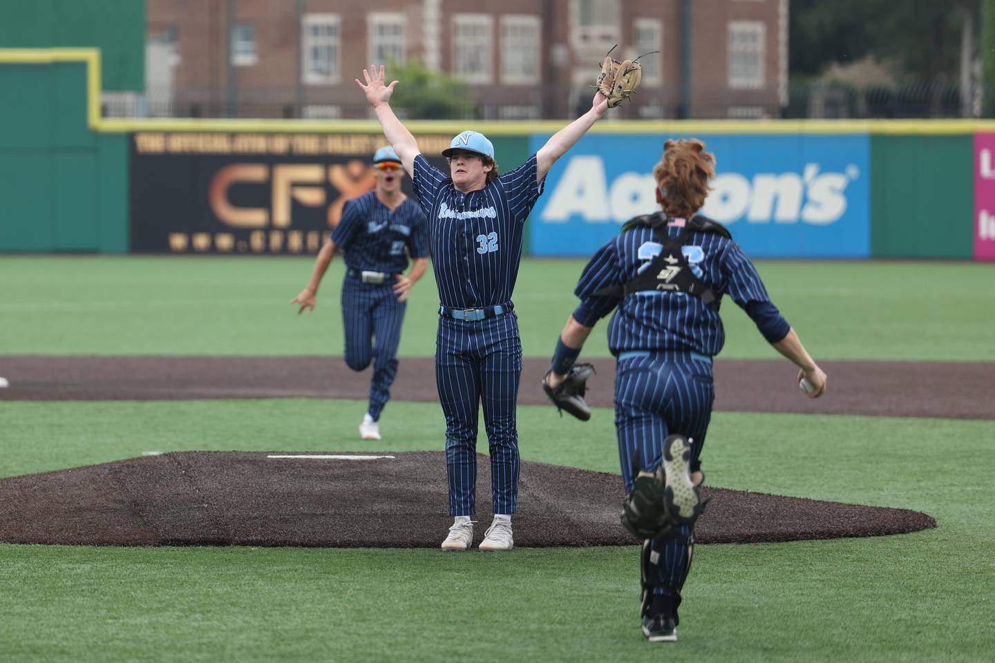 Nazareth’s Finn O’Meara throw his hands up after recording a title clinching strike out against Glenwood in the IHSA Class 3A State championship. Saturday, June 11, 2022 in Joliet.