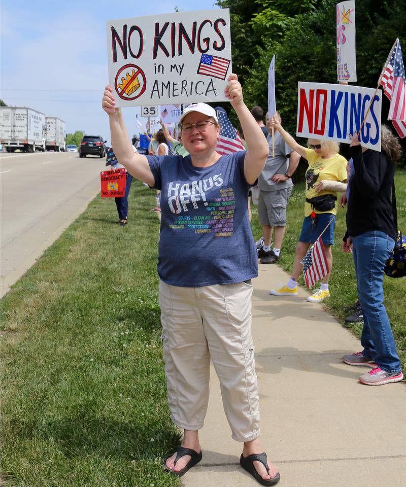 Oswego Village Trustee Karin McCarthy-Lange holds a sign at the No Kings Protest in Yorkville on Saturday, June 14, 2025.