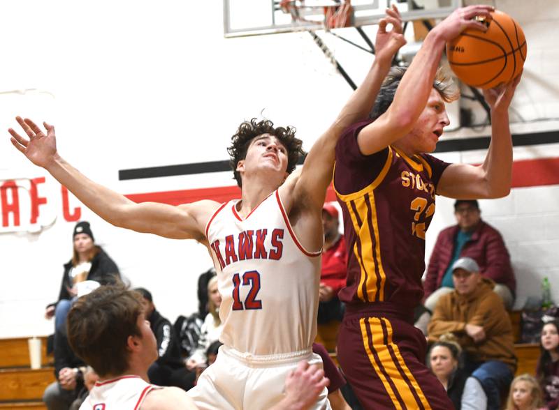 Oregon's Quinn Plescia (12) rebounds against Stockton's Ari Zink (32) on Saturday, Dec. 13 at the 64th Annual Forreston Holiday Basketball Tournament held at Forreston High School.
