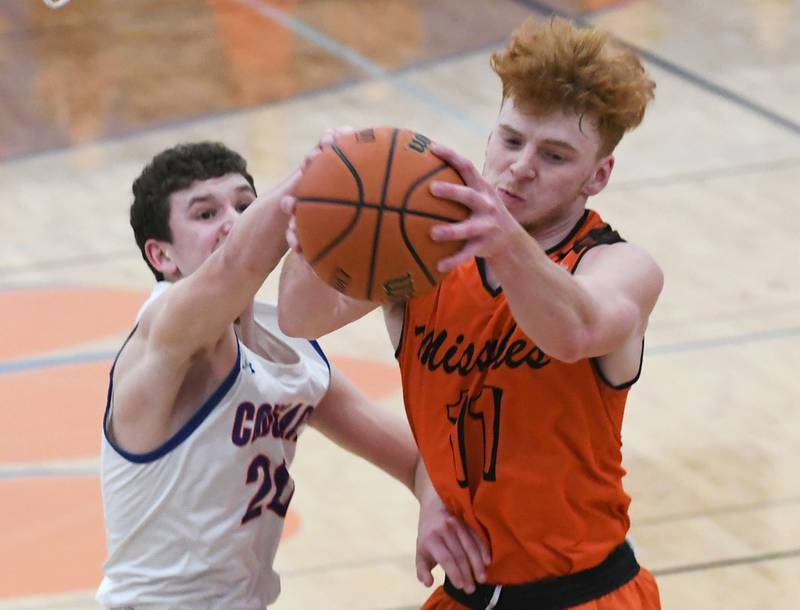 Milledgeville's Connor Nye (11) and Eastland's Peyton Spears (20) battle for a rebound during 1A regional action in Lanark on Saturday.