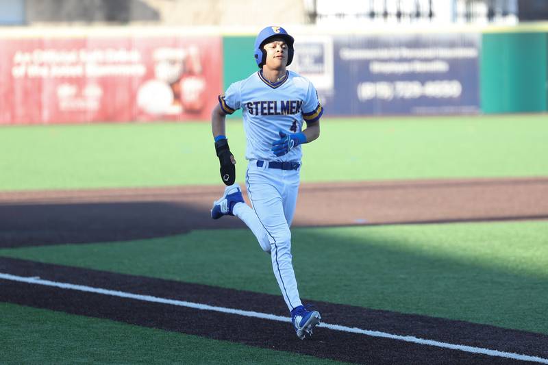 Joliet Central’s Adnrew Nixon trots home to score on an error by Aurora East on Monday, Mar. 11th in Joliet.