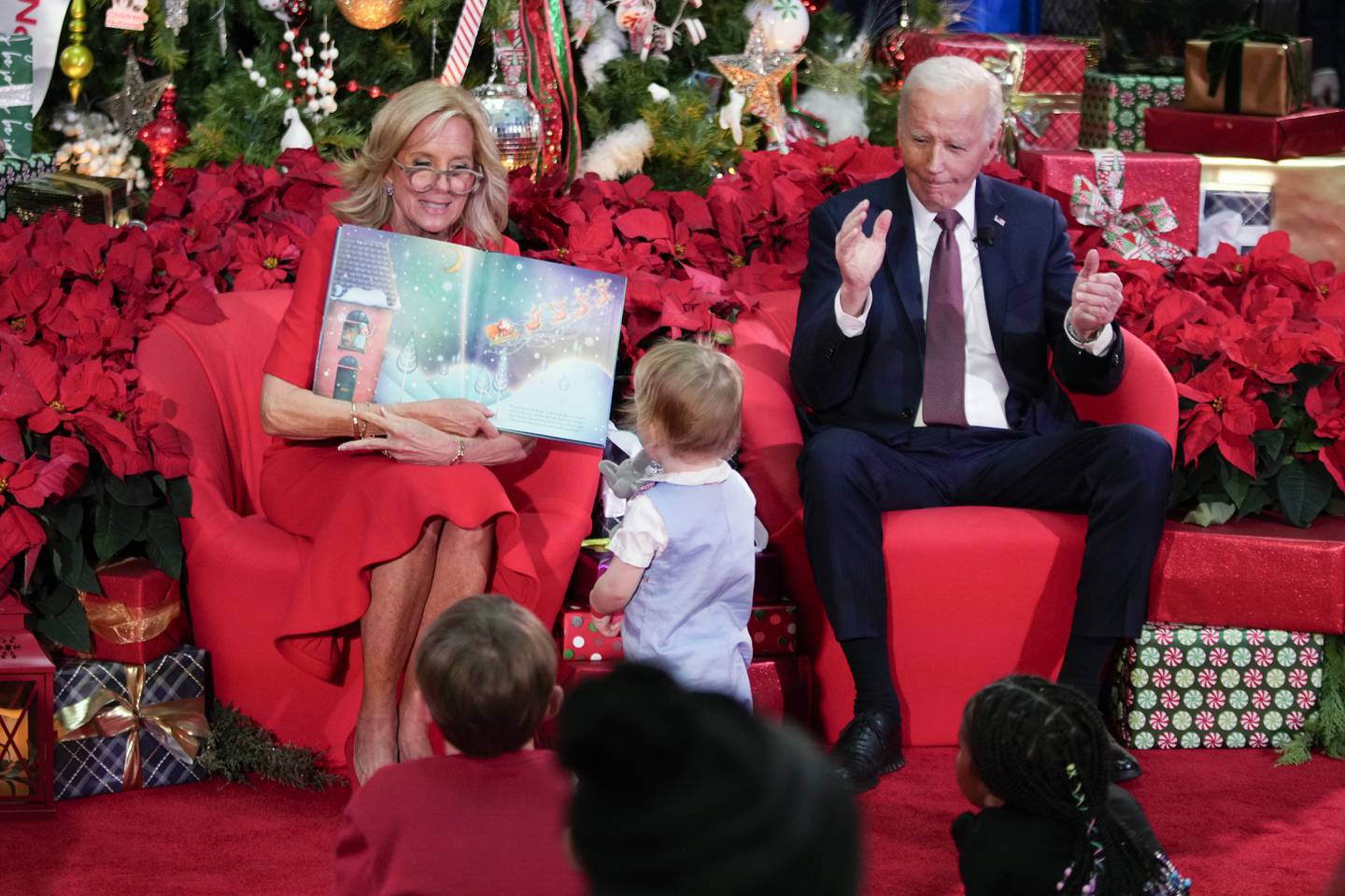 President Joe Biden and first lady Jill Biden, as she reads "'Twas the Night Before Christmas," visit patients and families at the Children's National Hospital in Washington on Friday.