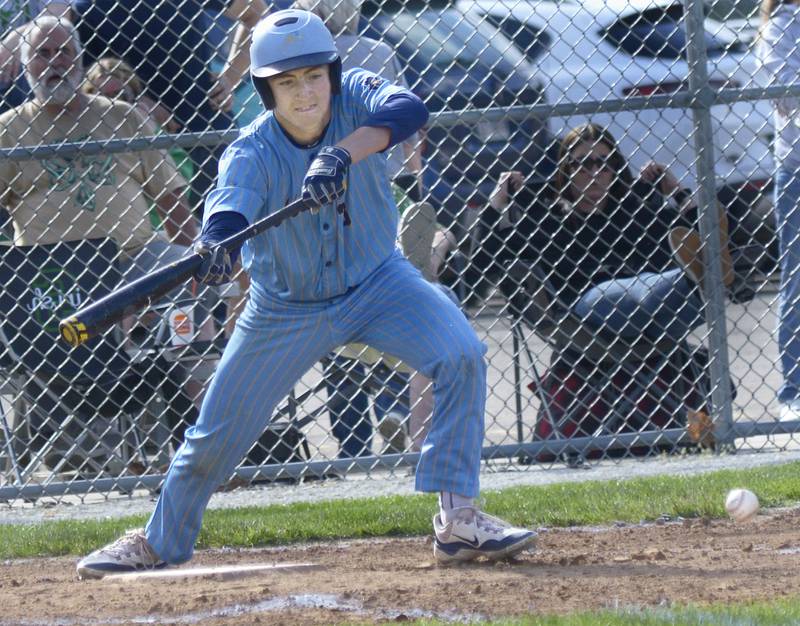 Marquette’s Carson Zellers puts down a bunt against Seneca Tuesday at Masinelli Field in Ottawa.