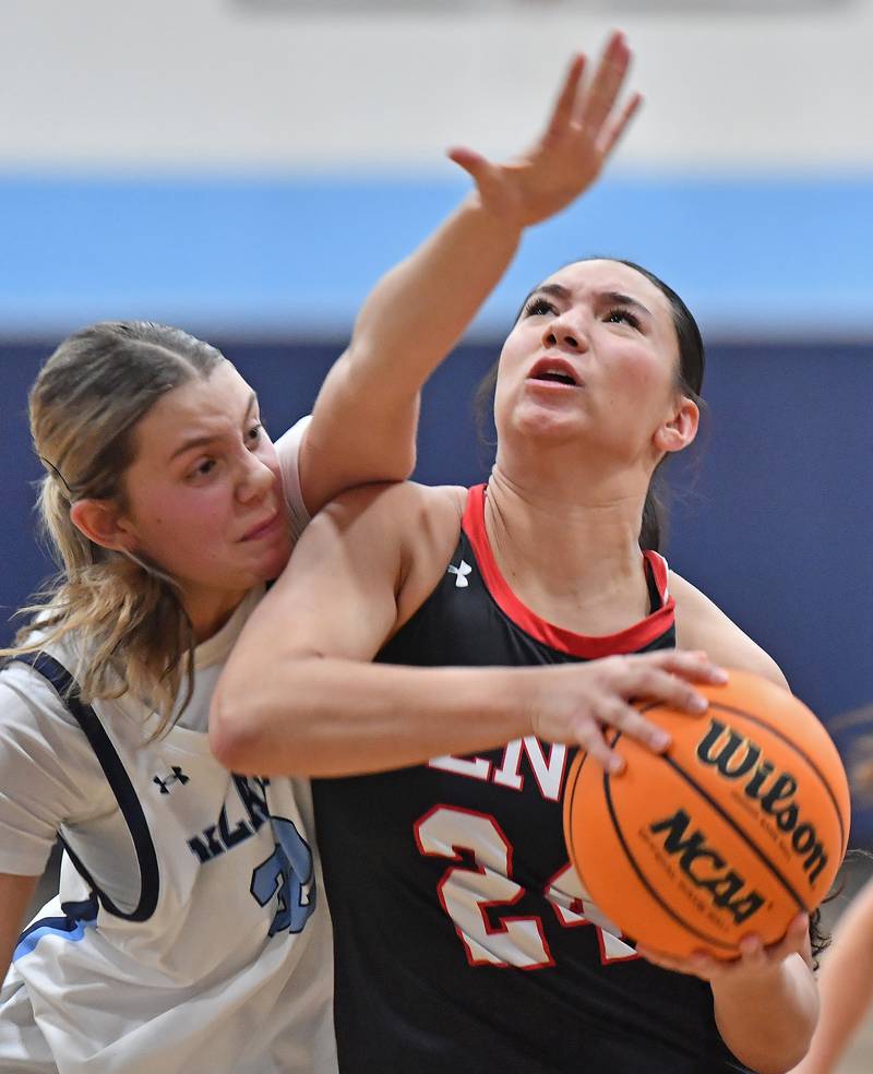Benet’s Emma Briggs (right) is fouled by Nazareth’s Stella Sakalas as she lays the ball up during a game on December 13, 2025 at Nazareth Academy in LaGrange Park.
