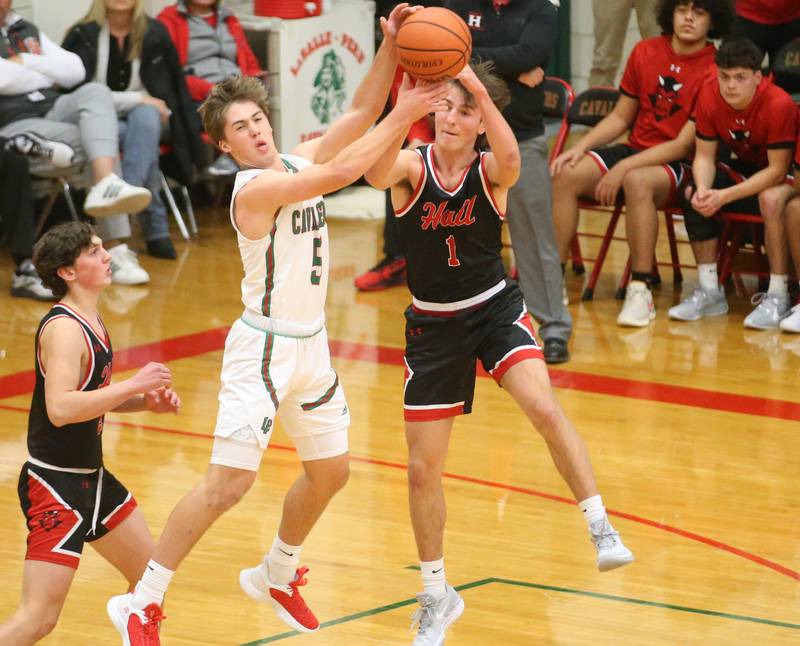 L-P's Seth Adams and Hall's Joseph Bacidore jump in the air to pull down a rebound on Tuesday, Nov., 28, 2023 in AJ Sellett Gymnasium at L-P High School.