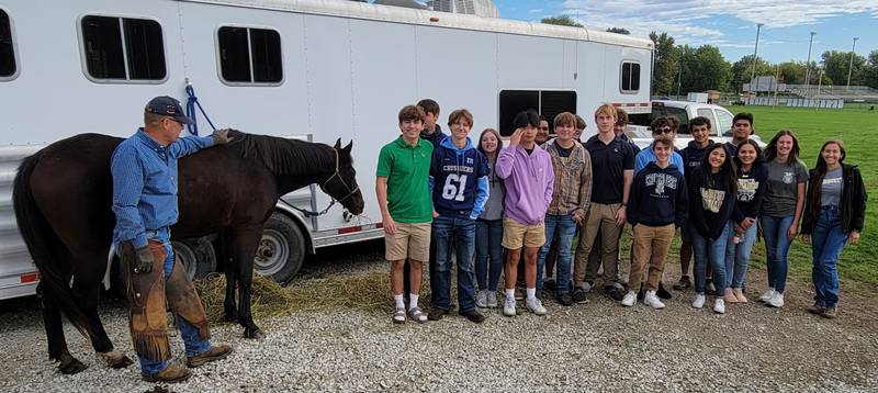 Don Haag, a professional horseshoer from Pontiac, and his 20-year-old quarterhorse, Romo, pose with the Marquette FFA class on Friday morning in Ottawa.