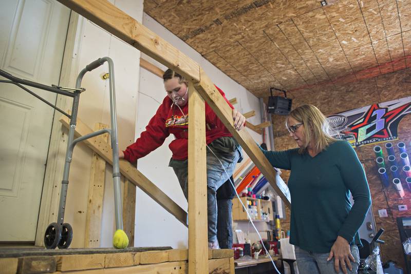 Tracy Elder helps her daughter up the stairs at the house. Carlie believes she contracted COVID at her wedding.