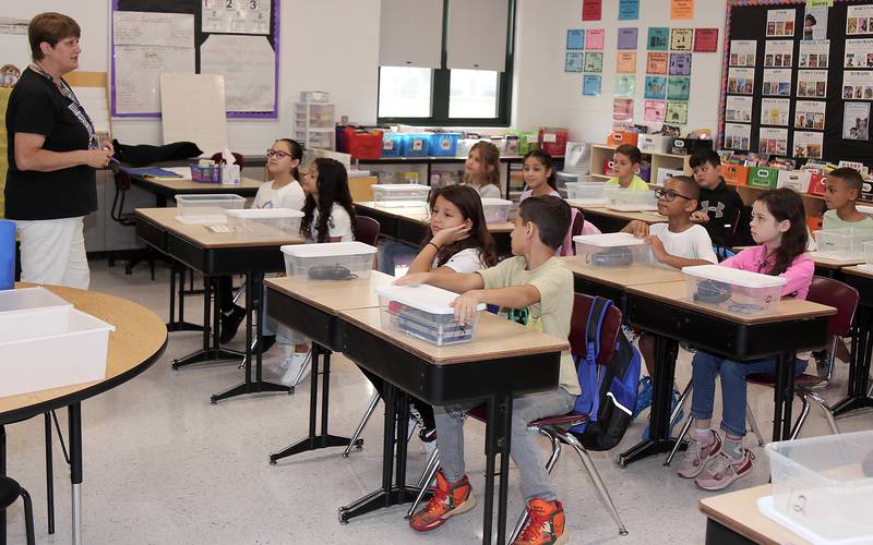 Fourth grade teacher Carolyn Olson welcomes her students on the first day of school at Emily G. Johns School in Plano on Thursday, Aug. 17, 2023.