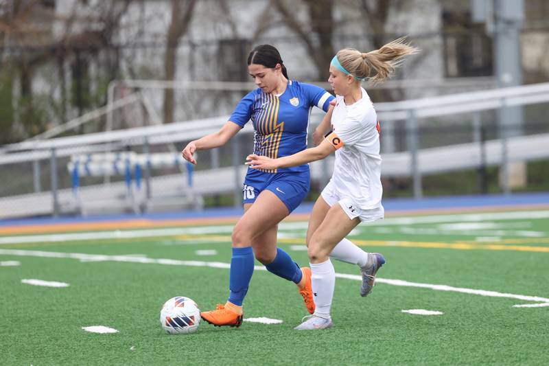 Joliet Central’s Gisselle Rangel works the ball away from Plainfield East’s Delaney Shrupsha on Thursday, April 11, 2024.