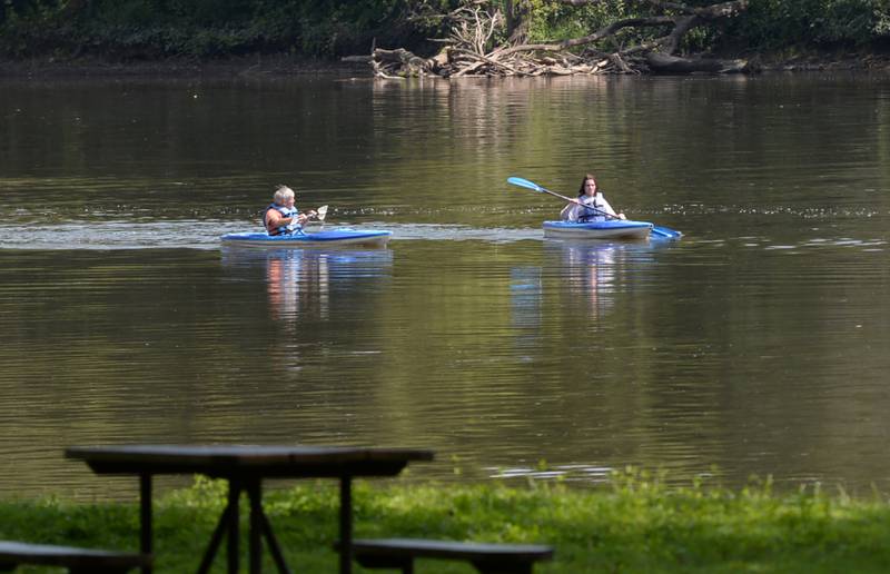 Two kayakers make their way south on the Rock River  toward the Castle Rock State Park boat launch on Tuesday, Aug. 13, 2024. Oregon firefighters were called out three times over the weekend to rescue paddlers from the river after their canoe or kayak tipped over after hitting debris. Recent flooding on the river has left trees and branches submerged below the river's surface.