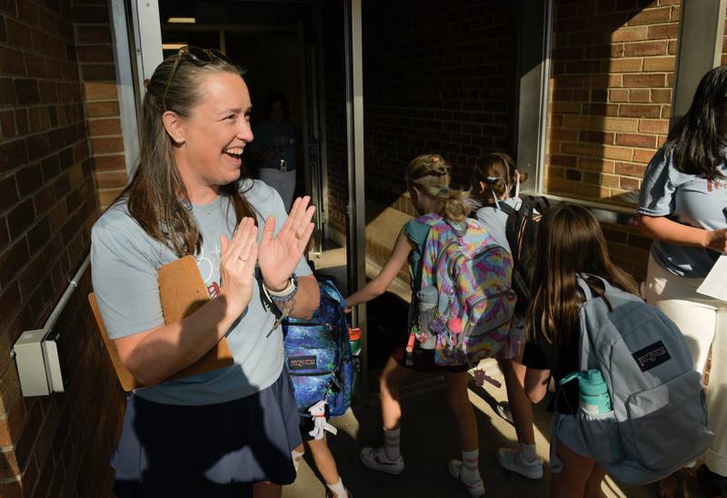 Davis Elementary STEM teacher Megan Oster welcomes students on the first day of class in St. Charles on Wednesday, Aug 13, 2025.
