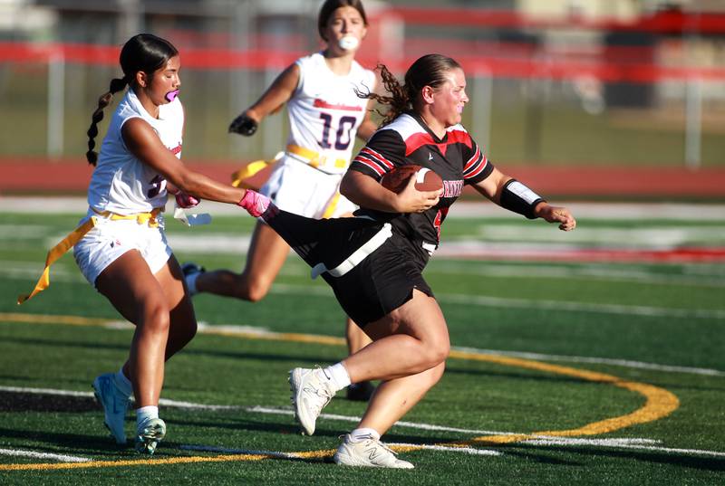 Yorkville’s Kayla Kersting (right) is pulled back by West Aurora’s Sarahi Carlos during a flag football game Wednesday, Sept. 4, 2024 in Yorkville.