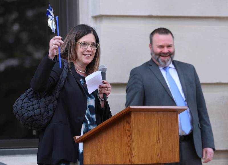 Prosecutor Jo Tracy, of the DeKalb County State's Attorney's Office, speaks as State's Attorney Riley Oncken looks on Wednesday, April 29, 2026, during Hands Around the Courthouse at the courthouse in Sycamore. The event was held to mark Child Abuse Prevention Month.