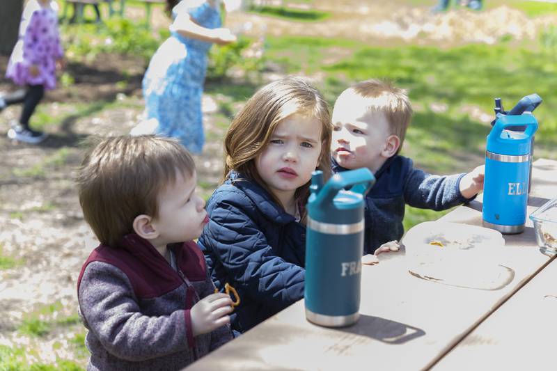 Franklin, Eleanor and Theodore Bouche' enjoy pretzels at the Downers Grove Park District Country in the Park on Saturday, May 3, 2025  in Downers Grove.